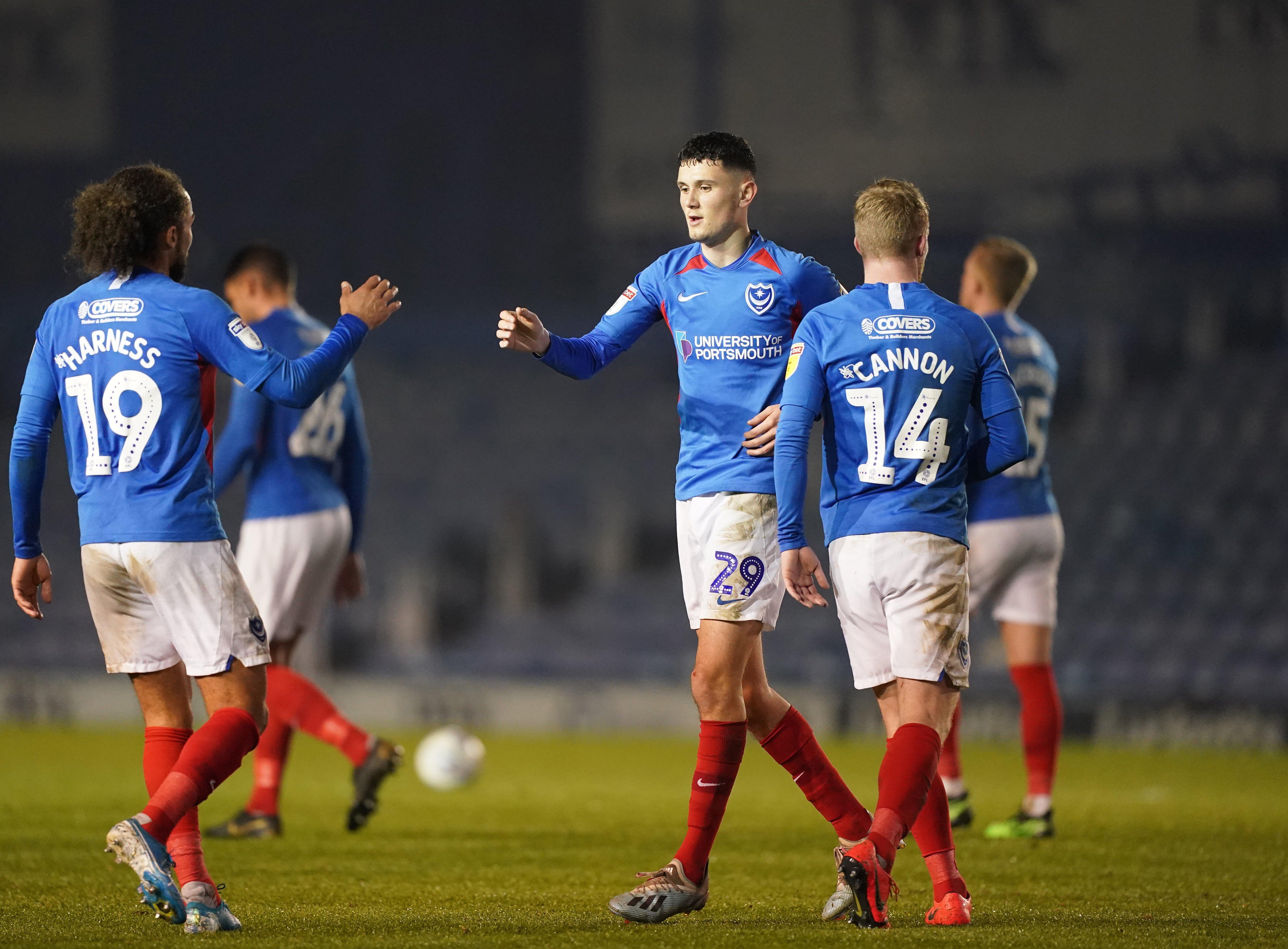 Leon Maloney celebrates his first Pompey goals with Marcus Harness and Andy Cannon. Picture: Sean Ryan