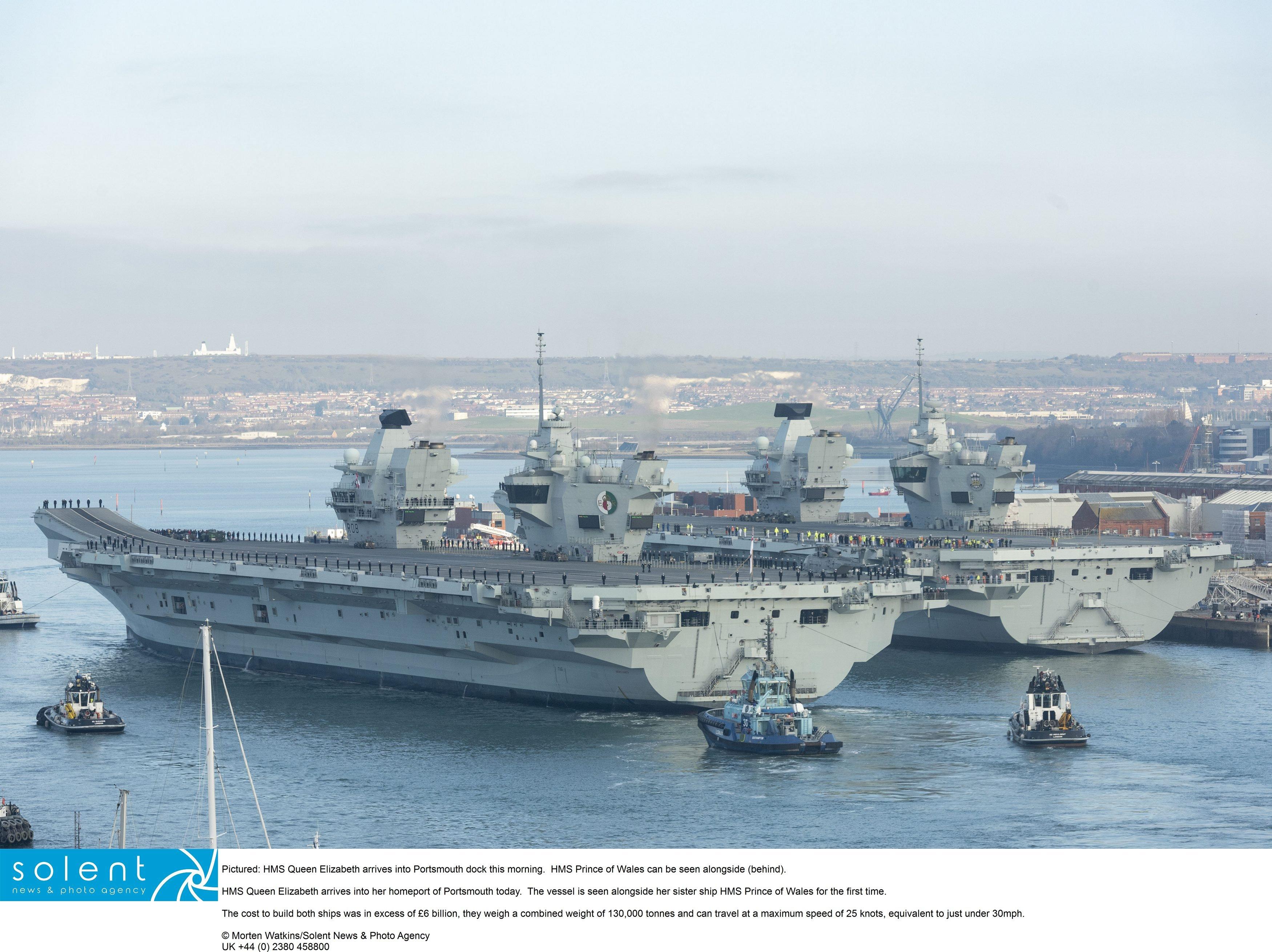 HMS Queen Elizabeth arrives into Portsmouth dock this morning.  HMS Prince of Wales can be seen alongside (behind).