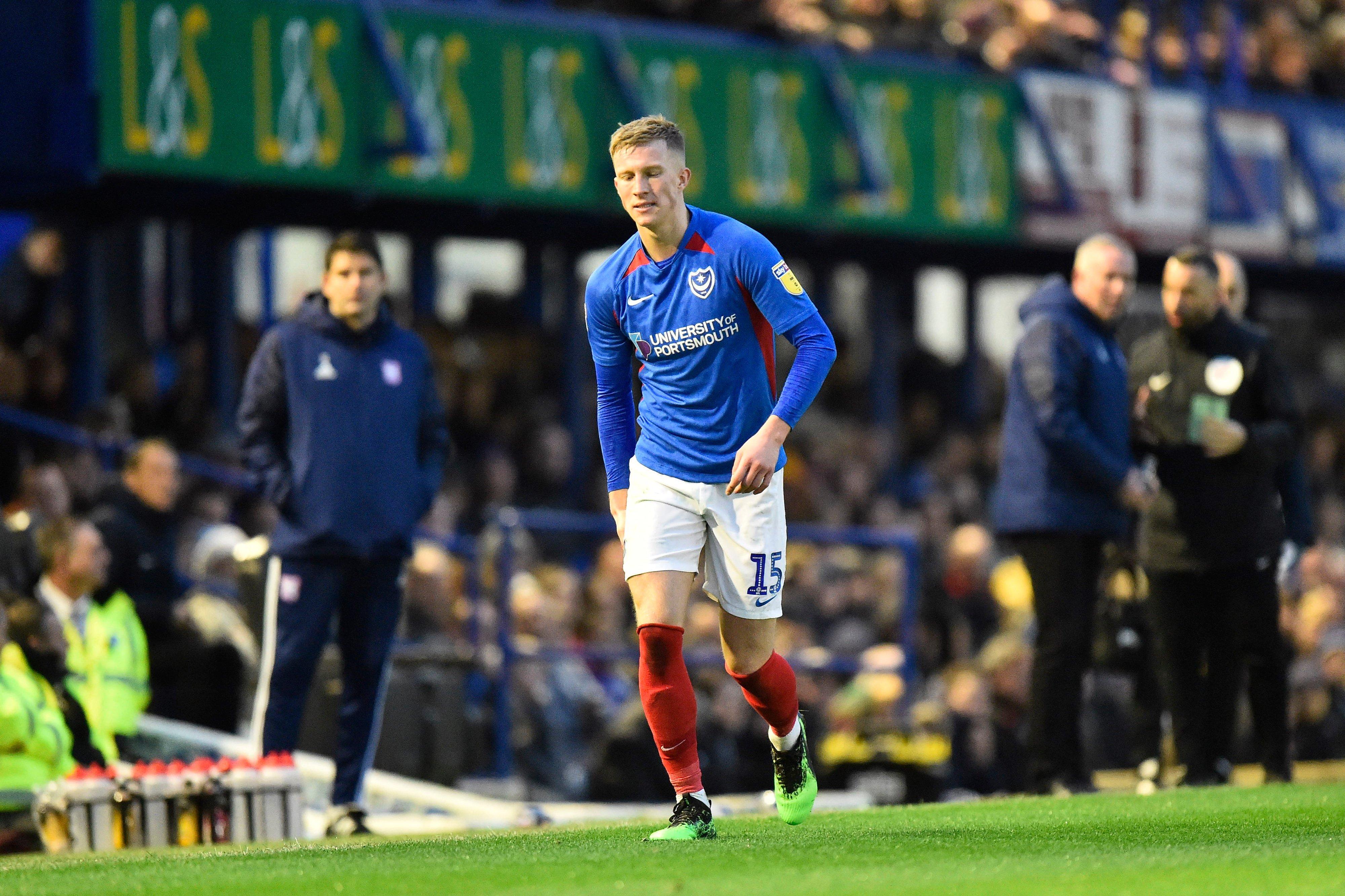 Ross McCrorie holds his hamstring shortly before being substituted during Pompey's 1-0 win over Ipswich. Picture: Graham Hunt