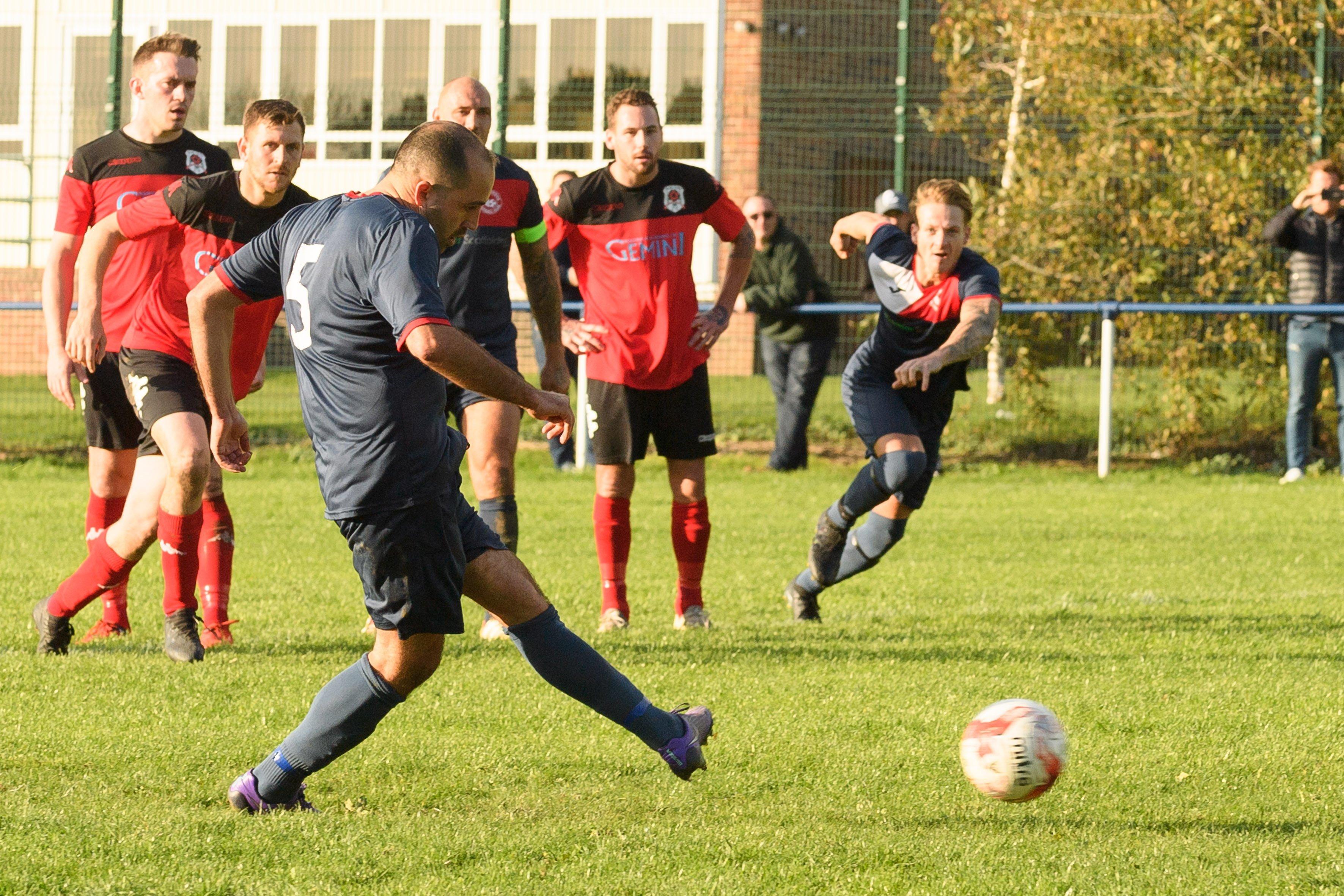 Adam Fisher about to see his penalty saved by Bush Hill keeper Niall Devereaux