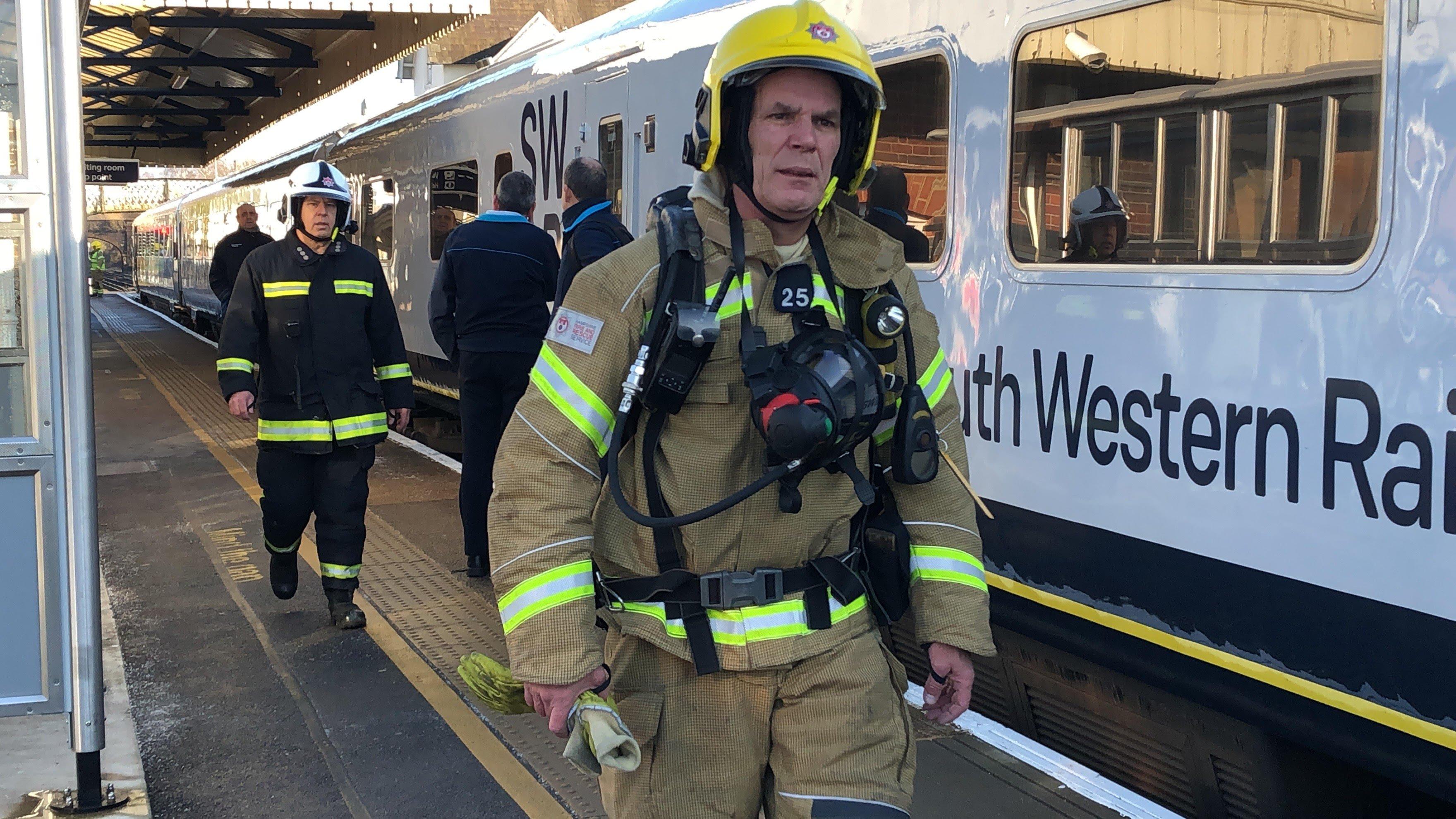 About 25 firefighters from across Hampshire attended the incident in Petersfield. Pictured: a firefighter with a breathing apparatus approaches the affected carriage. Photo: Tom Cotterill