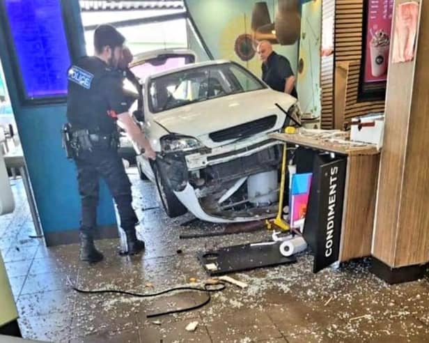 Man injured as car crashes into busy McDonalds
