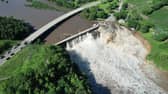 Building swept into Blue Earth River as Rapidan Dam suffers partial failure.
