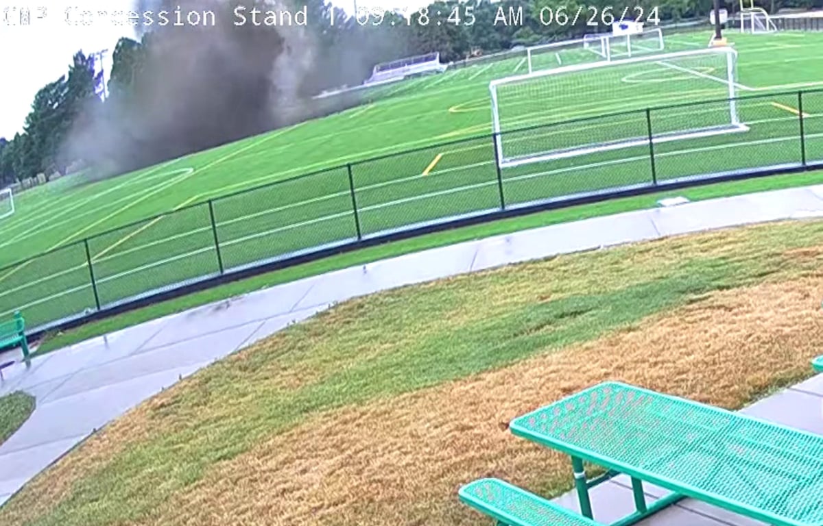 Giant 100ft wide sinkhole appears on football pitch and swallows floodlights and benches