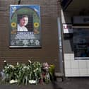 Flowers are left by a mosaic dedicated to Brazilian Jean Charles de Menezes outside Stockwell Underground Station on the tenth anniversary of his death in London on July 22 2015.