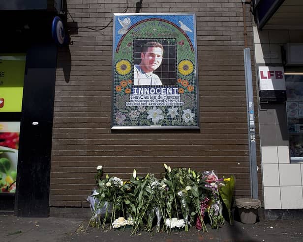 Flowers are left by a mosaic dedicated to Brazilian Jean Charles de Menezes outside Stockwell Underground Station on the tenth anniversary of his death in London on July 22 2015.