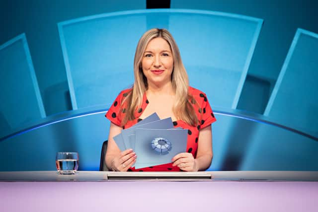 Victoria Coren Mitchell, wearing a red polka dot dress, behind the desk presenting Only Connect (Credit: BBC/Parasol Media Limited/Rory Lindsay)