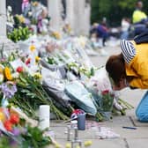 A woman is upset outside Buckingham Palace, London, following the death of Queen Elizabeth II on Thursday September 8, 2022. Picture date: Friday September 9, 2022.