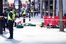 Police officers at the scene after three people have been taken to hospital following reports of stabbings at Bishopsgate in London. Picture date: Thursday October 6, 2022.