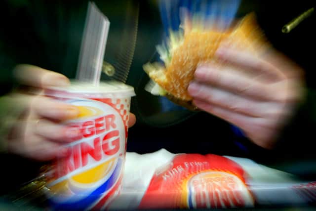 A man eats his lunch at a Burger King restaurant.