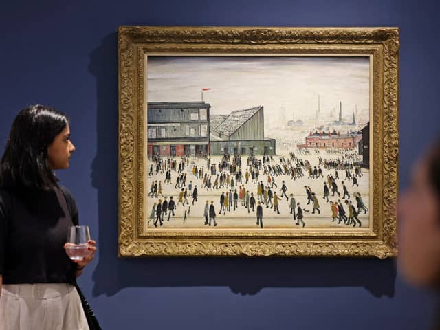 A visitor walks past "Going to the Match" by English artist LS Lowry from 1928, on display at a Christie's exhibition in Dubai on September 15, 2022