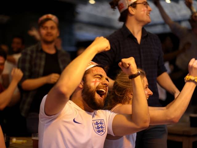 Football fans celebrate while watching the live broadcast of the final of the 2020 UEFA European Championships between England and Italy in the Oxford Arms pub in Camden on July 11, 2021 in London.