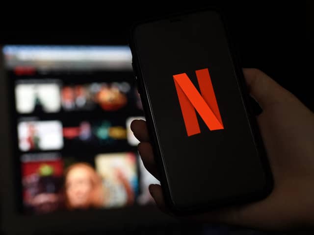 In this photo illustration a computer and a mobile phone screens display the Netflix logo on March 31, 2020 in Arlington, Virginia. (Photo by Olivier DOULIERY / AFP) (Photo by OLIVIER DOULIERY/AFP via Getty Images)