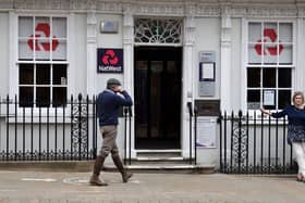 Customers use a NatWest bank on the High Street in Winchester, south west England on March 31, 2021. (Photo by ADRIAN DENNIS / AFP) (Photo by ADRIAN DENNIS/AFP via Getty Images)