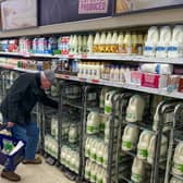 A customer shops for milk inside a Sainsbury's supermarket in east London on February 20, 2023.