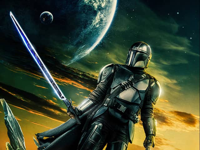 A promotional image for The Mandalorian S3, depicting Pedro Pascal as Din Djarin in front of a yellow and green sky (Credit: Disney+)