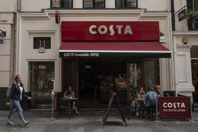 LONDON, ENGLAND - AUGUST 31: Customers sit outside a Costa Coffee store on August 31, 2018 in London, England. Coca-Cola Co. is to buy the U.K. chain Costa Coffee for £3.9 billion GBP, ($5.1 billion USD). (Photo by Dan Kitwood/Getty Images)