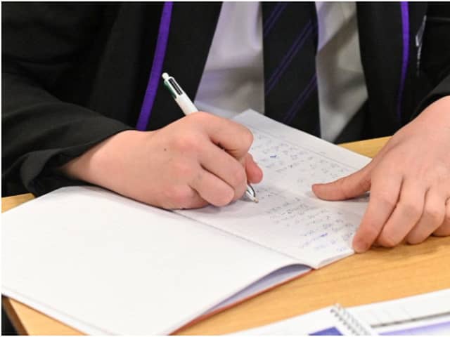 Year 11 students, wearing face coverings, take part in a GCSE maths class at Park Lane Academy in Halifax, northwest England on March 8, 2021 as schools reopen following the easing of lockdown restrictions. (Photo by Oli SCARFF / AFP) (Photo by OLI SCARFF/AFP via Getty Images)