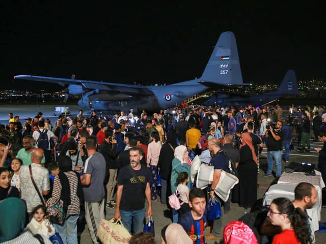 People evacuated from Sudan arrive at a military airport in Amman on 24 April 2023 (Photo: KHALIL MAZRAAWI/AFP via Getty Images)
