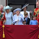 Britain's Queen Elizabeth II (C) stands with from left, Britain's Prince Charles, Prince of Wales, Britain's Prince Louis of Cambridge, Britain's Catherine, Duchess of Cambridge, Britain's Prince George of Cambridge, Britain's Princess Charlotte of Cambridge, and Britain's Prince William, Duke of Cambridge, to watch a special flypast from Buckingham Palace balcony following the Queen's Birthday Parade, the Trooping the Colour, as part of Queen Elizabeth II's platinum jubilee celebrations, in London on June 2, 2022.  (Photo by DANIEL LEAL/AFP via Getty Images)