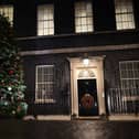 A Christmas tree stands illuminated outside number 10 Downing Street (Getty Images)