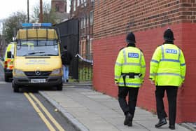 Police officers patrol the area around a house in Liverpool, north west England (PAUL ELLIS/AFP via Getty Images)