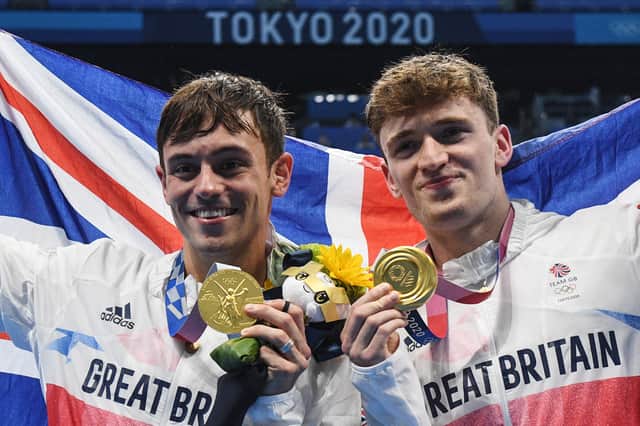 Gold medallists Britain's Thomas Daley (L) and Britain's Matty Lee poses with their medals after wining the men's synchronised 10m platform diving final event during the Tokyo 2020 Olympic Games (Photo by Oli SCARFF / AFP) (Photo by OLI SCARFF/AFP via Getty Images)