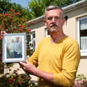 Leigh Blanning with a photo of his late father, John.