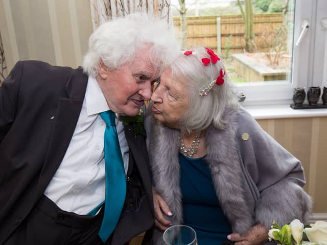 Joan Neininger & Ken Selway share a kiss at their wedding reception at Hannover Court, Cinderford, Gloucestershire. 