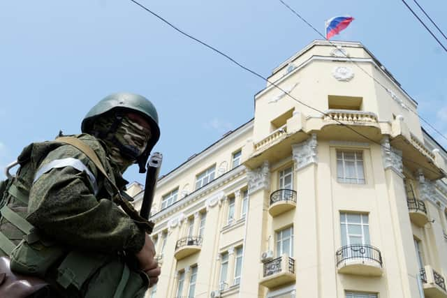 A member of Wagner group stands guard in a street in the city of Rostov-on-Don