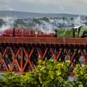 Flying Scotsman passes over the Forth Bridge as part of a series of events to celebrate her centenary. The world famous steam locomotive left Edinburgh before heading north to Aberdeen. 