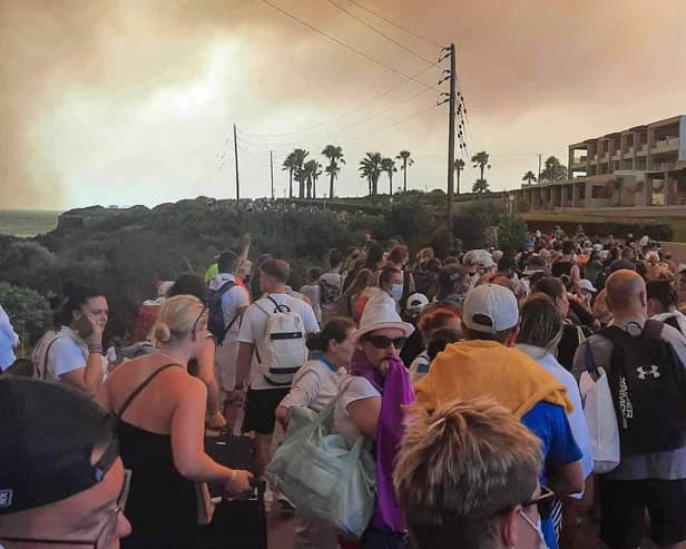 Tourists are evacuated from hotels during a wildfire on the Greek island of Rhodes on July 22, 2023.