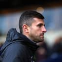 Portsmouth manager John Mousinho looks on during a match
