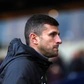 Portsmouth manager John Mousinho looks on during a match