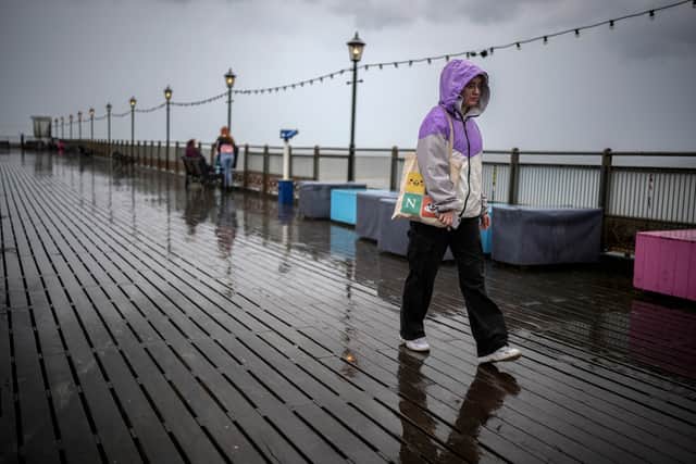 Holidaymakers brave a downpour on Skegness Pier on July 18, 2023 in Skegness, England. As wildfires and a heatwave grip most of Europe the inclement weather in UK is not set to change soon as the MET office forecasts weather patterns on the UK are to remain the same.
