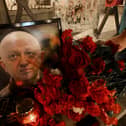  A man lays flowers at a makeshift memorial in honour of Yevgeny Prigozhin.
