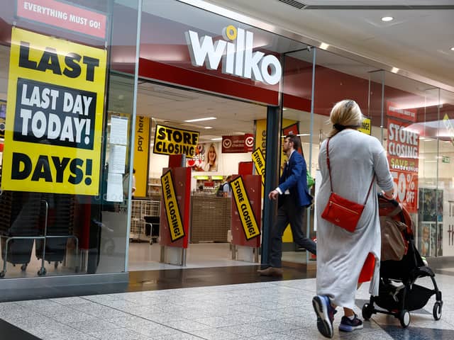  Shoppers walk past a Wilko store in Putney on September 12.