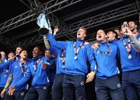 Carl Baker (centre) and his Pompey team-mates celebrate the League Two title on Southsea Common in May 2017. Picture: Joe Pepler