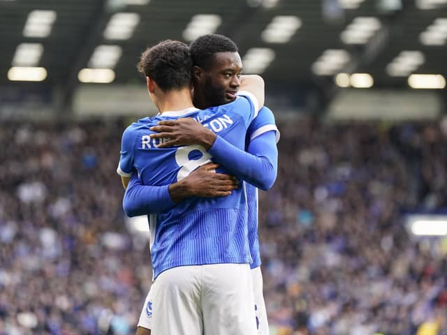 Abu Kamara is congratulated by Alex Robertson following his Pompey opener against Charlton in November