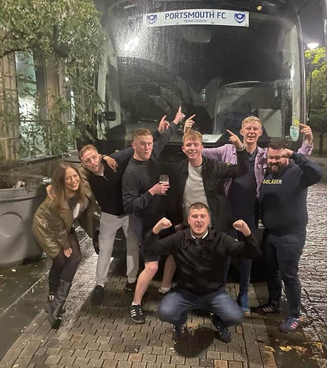 Rebecca Markham with her 'Pompey family' outside the team's coach at Chesterfield in November.