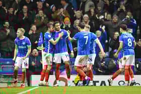 Kusini Yengi is congratulated by his Pompey team-mates following his goal against Bolton on Monday night