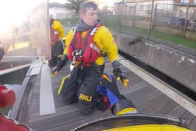 An RNLI crew has rescued a cat after it managed to get stcuk under a pontoon at East Cowes Marina. 
Pictured: The cat jumping to safety from the pontoon after being rescued. 