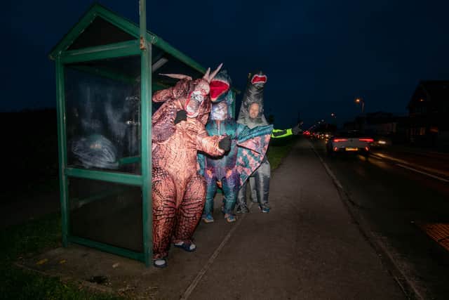 Graeme Lloyd and his friends are walking 15,000 steps a day in January in support of the Motor Neurones Disease Association. They are doing it in 8f inflatable dinosaur costumes. Pictured: Graeme Lloyd (tetradactyl), Tommy Russell (triceratops) and Steven Porter (brontosaurus) 