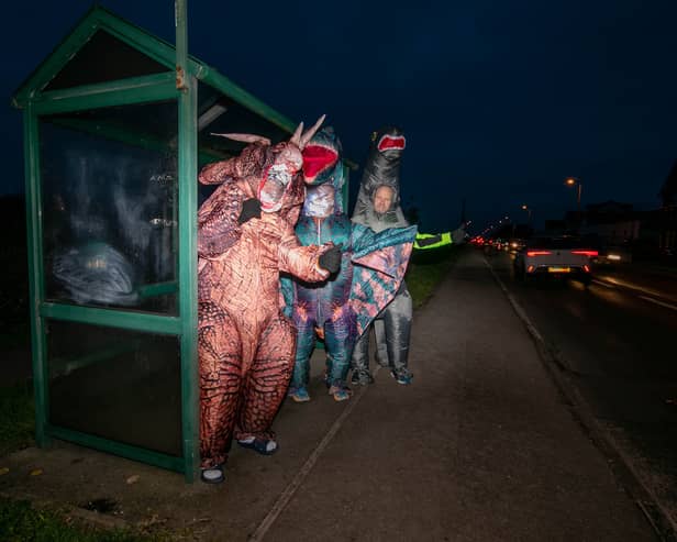 Graeme Lloyd and his friends are walking 15,000 steps a day in January in support of the Motor Neurones Disease Association. They are doing it in 8f inflatable dinosaur costumes. Pictured: Graeme Lloyd (tetradactyl), Tommy Russell (triceratops) and Steven Porter (brontosaurus) 