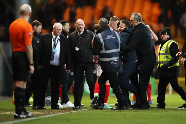 A Port Vale fans runs on the pitch to chase Referee Craig Hicks (not pictured) during the Sky Bet League One match at Vale Park, Stoke-on-Trent. Photo: Jess Hornby/PA Wire.