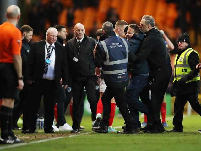 A Port Vale fans runs on the pitch to chase Referee Craig Hicks (not pictured) during the Sky Bet League One match at Vale Park, Stoke-on-Trent. Photo: Jess Hornby/PA Wire.