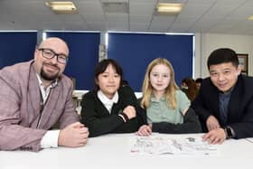 Pictured is: (l-r) Woodcroft Primary School's Barry Fanning, YiFei Li, Tabitha Nestor and headteacher of Nanjing Phoenix Garden City Primary School Xu Jianhua.