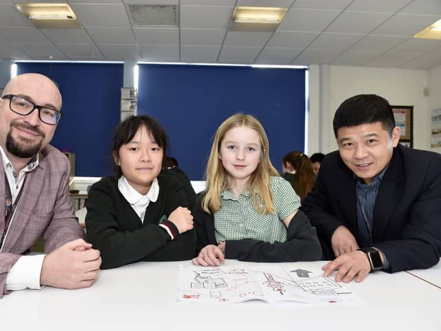 Pictured is: (l-r) Woodcroft Primary School's Barry Fanning, YiFei Li, Tabitha Nestor and headteacher of Nanjing Phoenix Garden City Primary School Xu Jianhua.