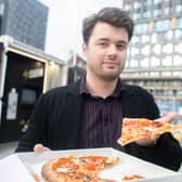 Reporter Joe Buncle tries pizza from a Pizza Rebellion vending machine.