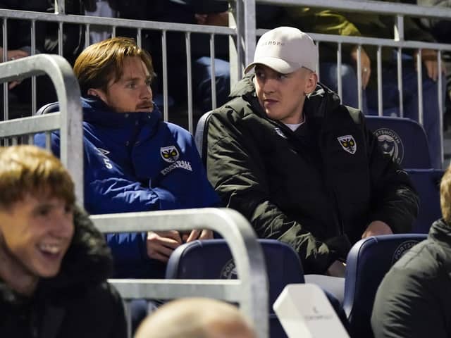 Ronan Curtis on the AFC Wimbledon bench during the Dons' EFL Trophy win against Pompey at Fratton Park in December